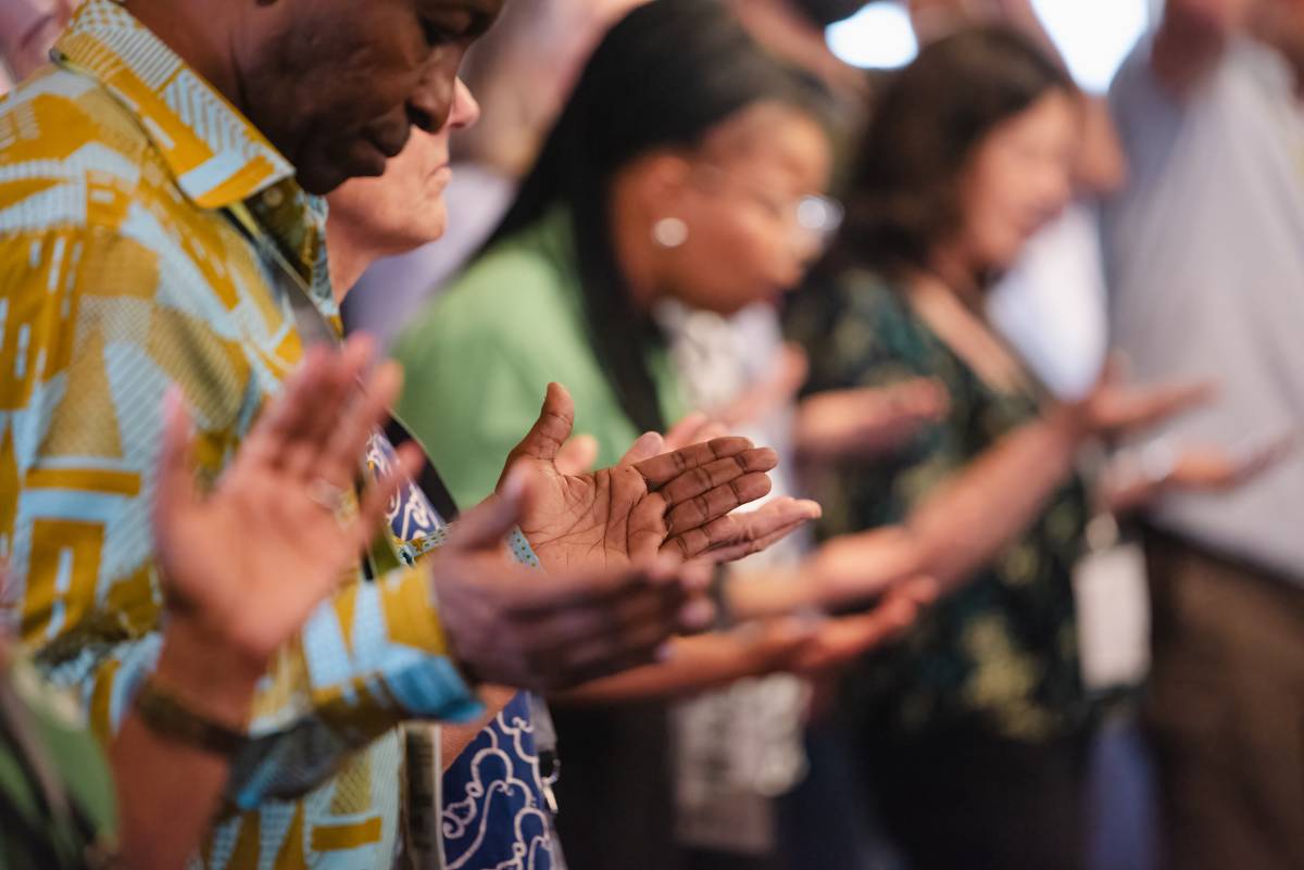 Hands of people worshipping in church.